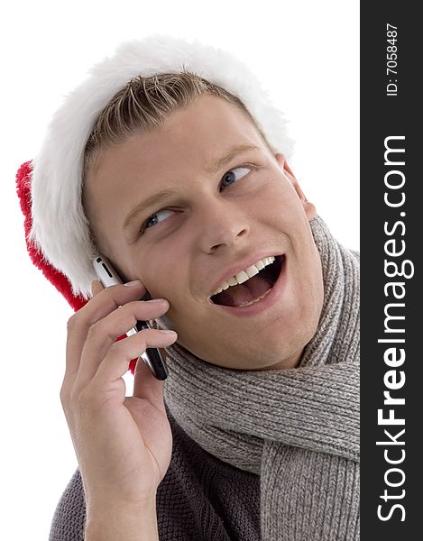 Smiling male with christmas hat talking on cell phone with white background