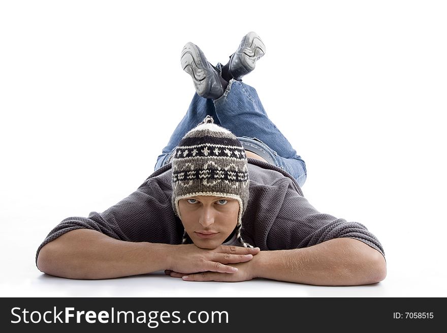 Laying young man wearing winter cap on an isolated white background