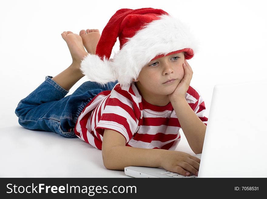 Young boy dressed as santa's elve, wishing for gifts on internet. Young boy dressed as santa's elve, wishing for gifts on internet