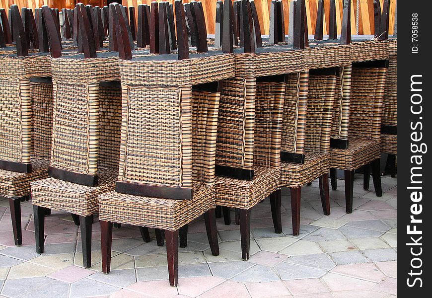 Picture of native chairs piled-up side down at the creek side in dubai