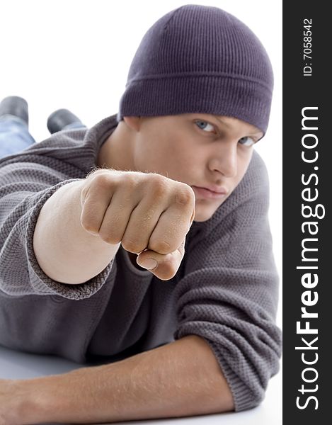 Handsome model with winter cap showing punch on an isolated background