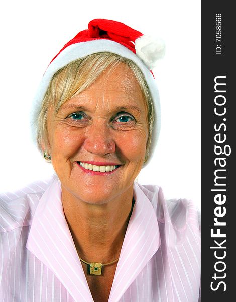 A businesswoman in her sixties with a Santa claus hat - smiling. Isolated over white. A businesswoman in her sixties with a Santa claus hat - smiling. Isolated over white.