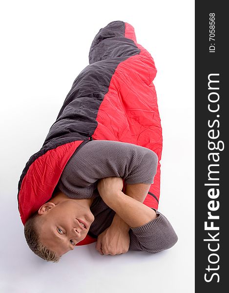 Young man covered himself with red sleeping bag
