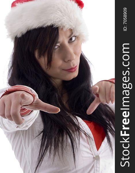 Attractive woman pointing with finger and wearing christmas hat on an isolated white background