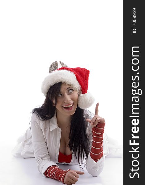 Sexy woman posing in front of camera and wearing christmas hat against white background