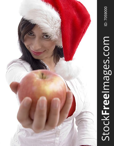 Sexy model with christmas hat showing apple on an isolated background