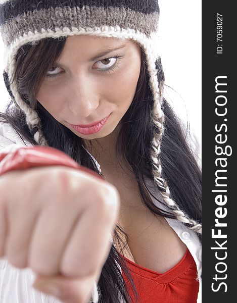 Young female posing with clenched fist on an isolated white background