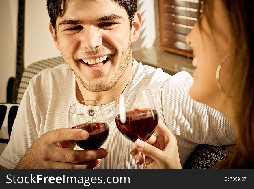 Happy young couple drinking wine