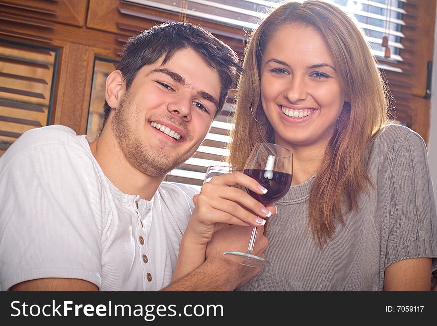 Happy young couple drinking wine