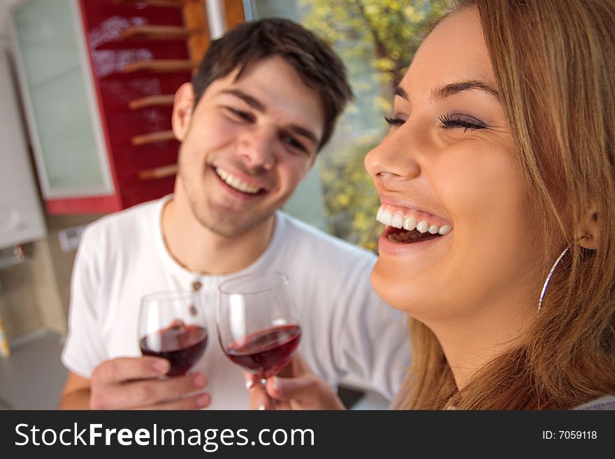 Happy young couple drinking wine