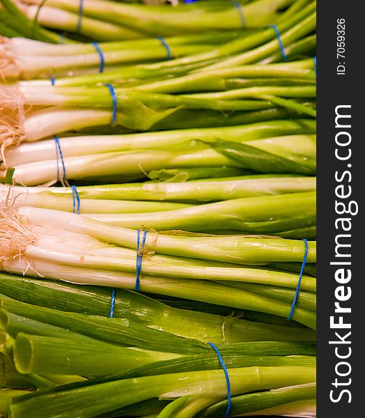 Fresh green and white onions at a vegetable market. Fresh green and white onions at a vegetable market