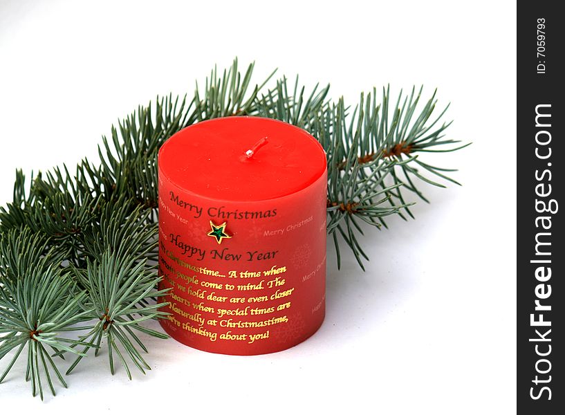 Red candle and fir branch as Christmas decoration