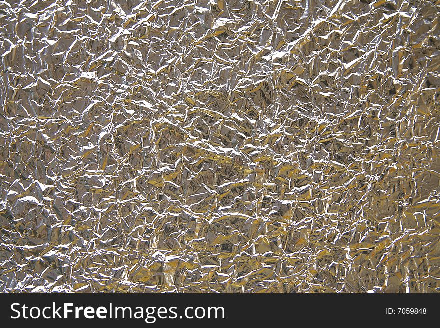 Crinkly and wrinkled aluminum foil perfect to use as a background. Crinkly and wrinkled aluminum foil perfect to use as a background