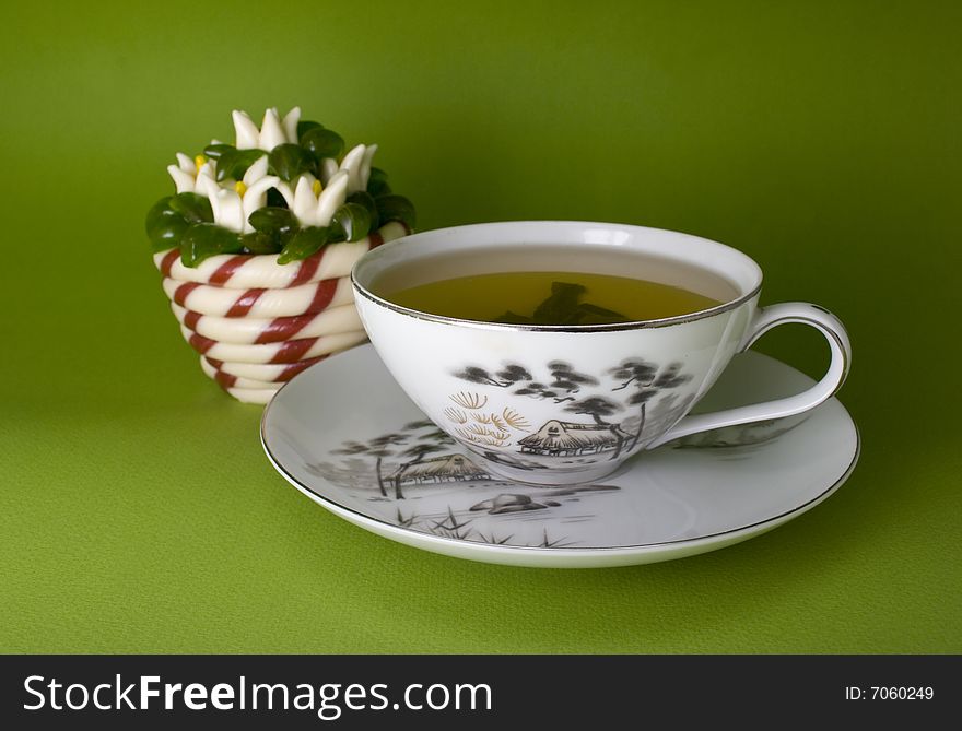 Tea cup and jellies close-up isolated