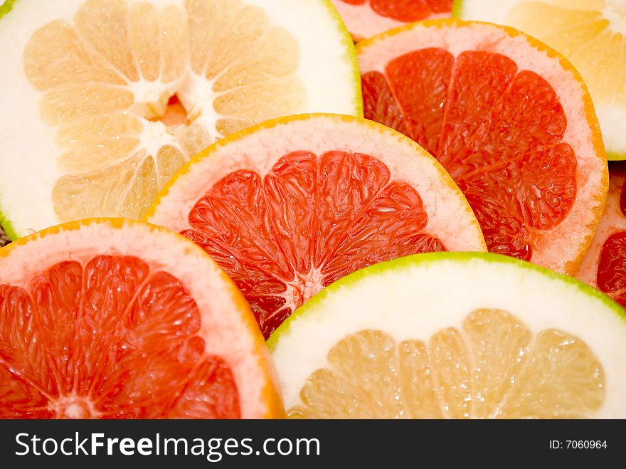 Citrus Fruits - res and green grapefruits, and glass of orange juice isolated on white