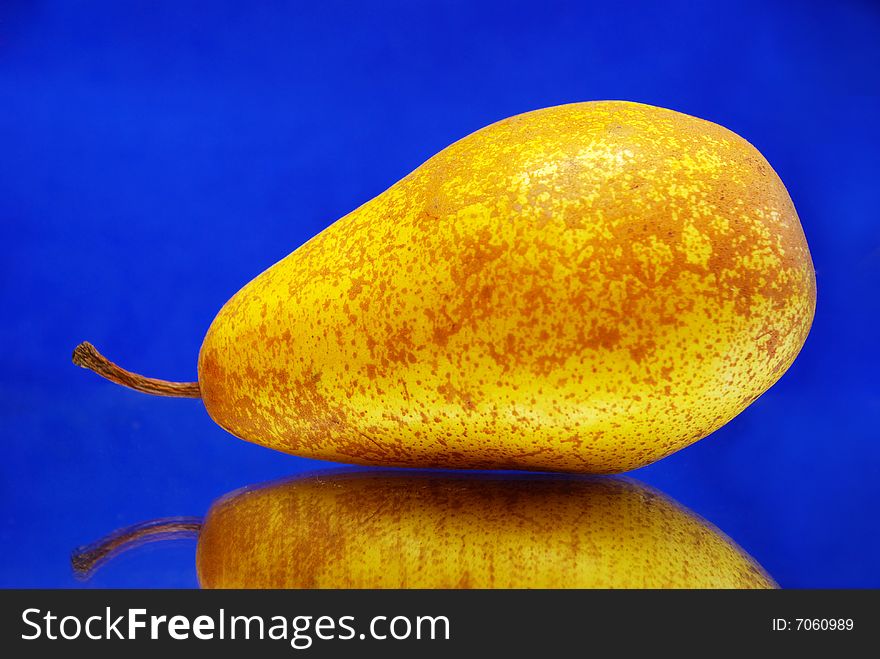 Yellow pear isolated over blue