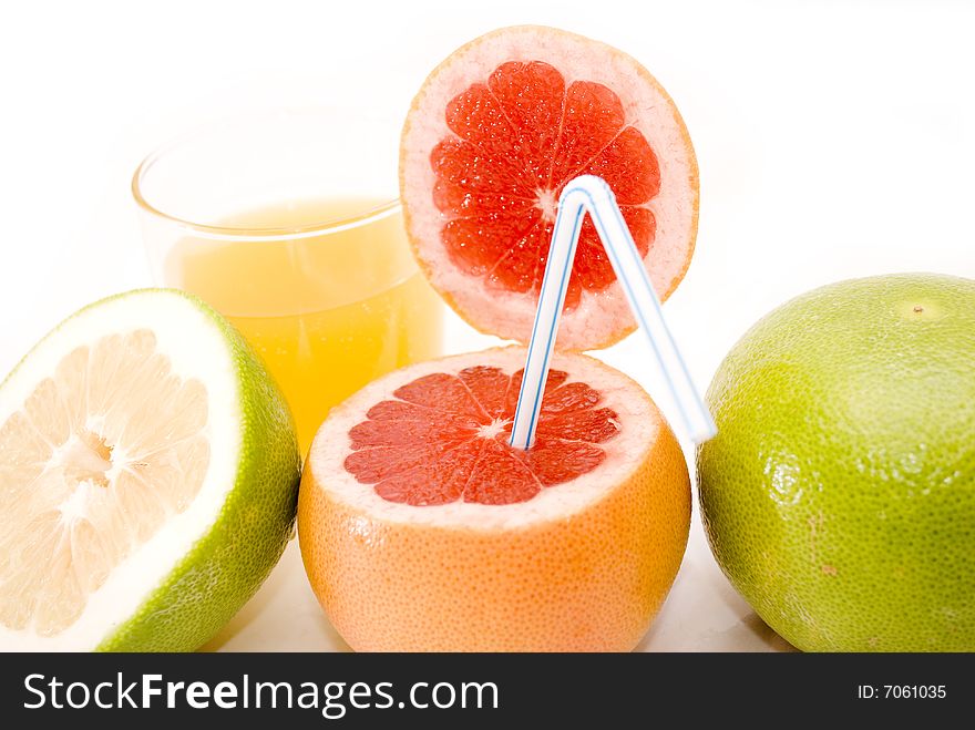 Citrus Fruits - res and green grapefruits, and glass of orange juice isolated on white