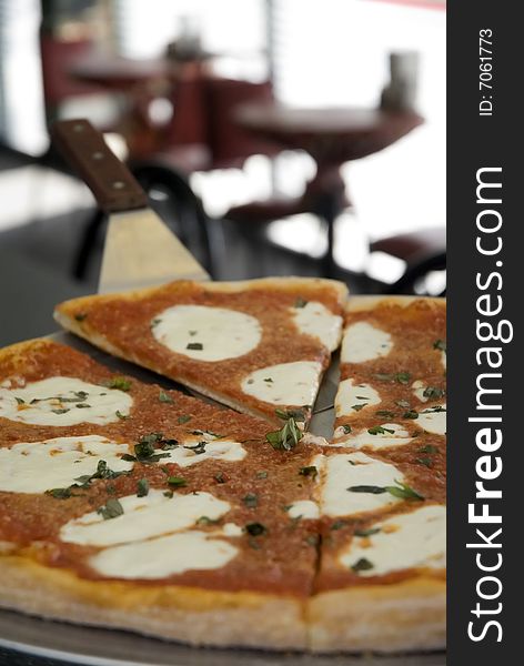 Sliced sicilian pizza in pizzeria. Sliced sicilian pizza in pizzeria