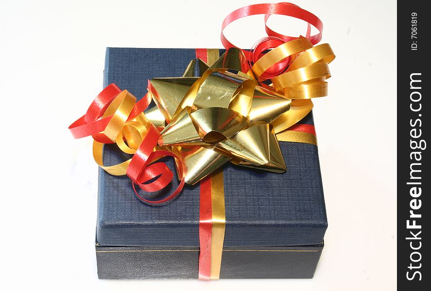 Colored gift box with red and gold ribbon