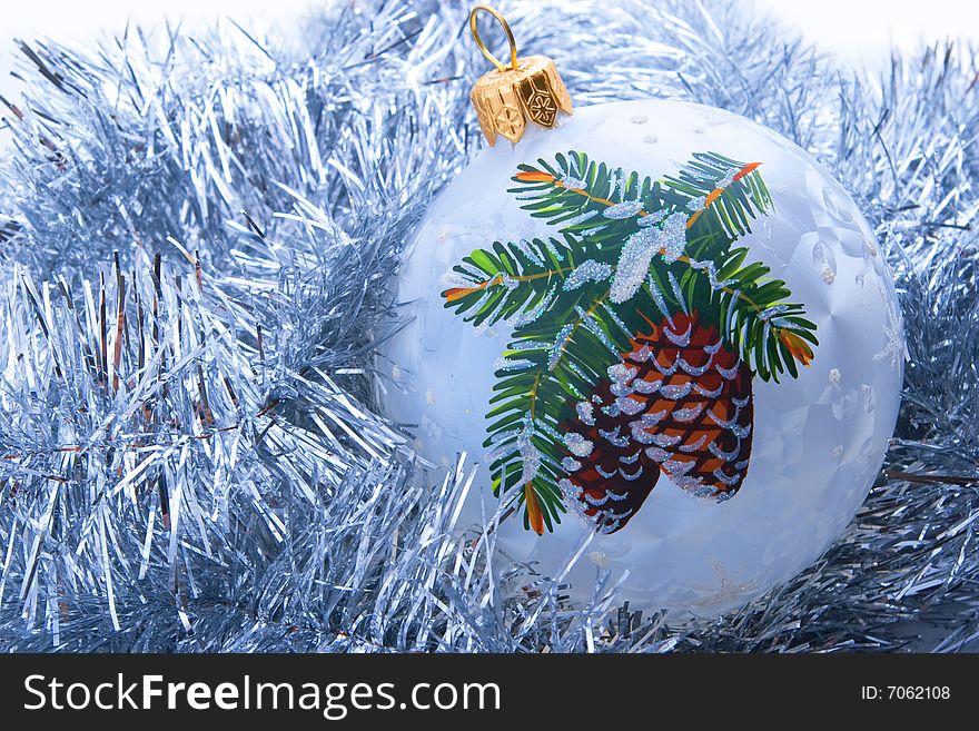 White decorated christmas ball on tinsel