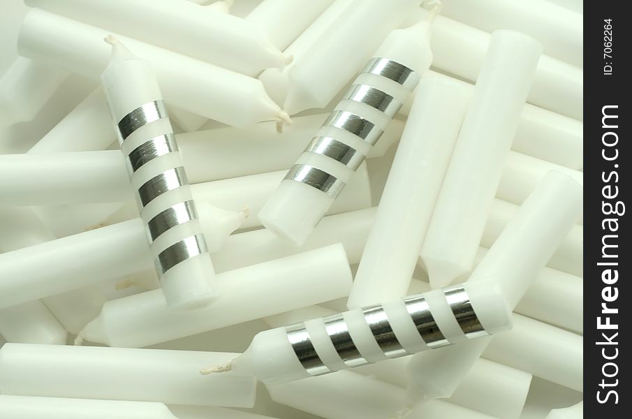 Many small white and silver candles for a holiday