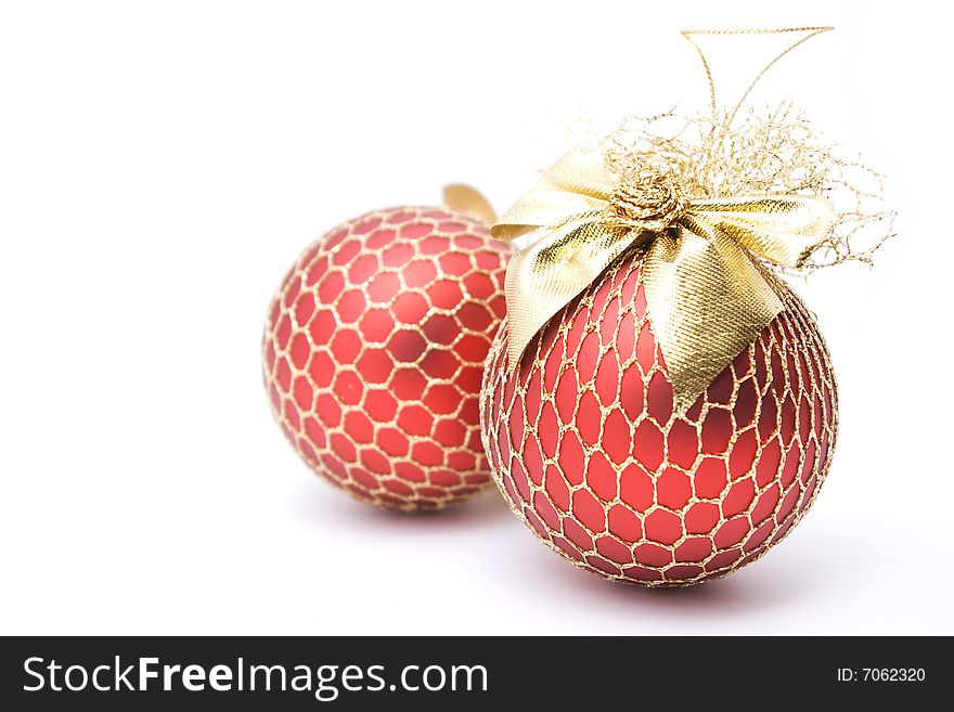Two red christmas balls decorated with golden net