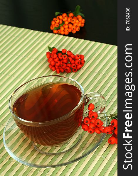 Glass tea cup and red berries. Glass tea cup and red berries