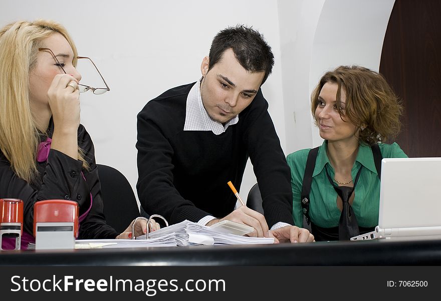 Successful business team working over a laptop computer and documents