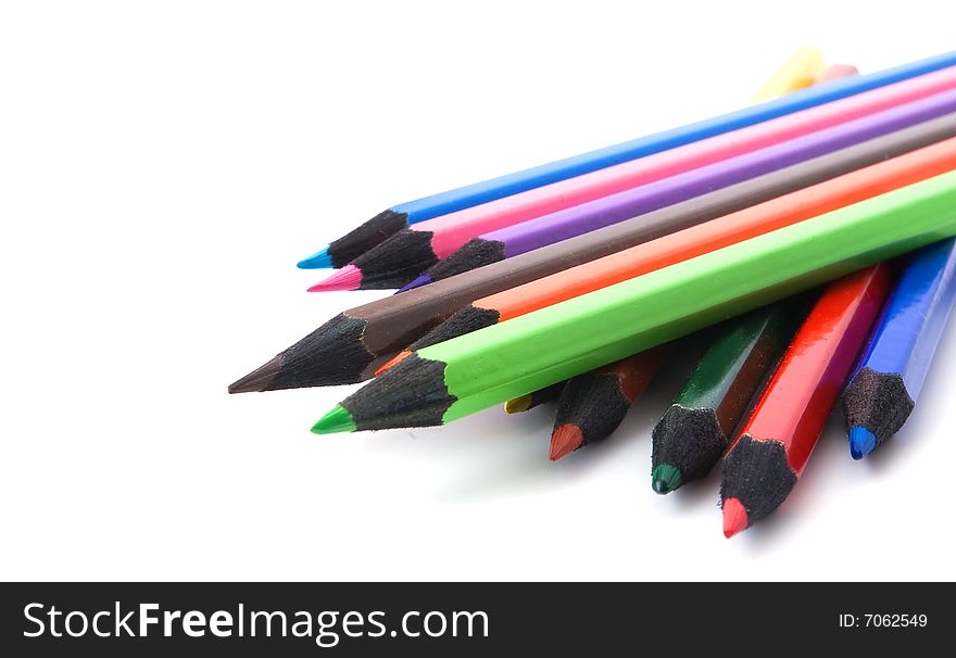 Stack of multicolored crayons on white