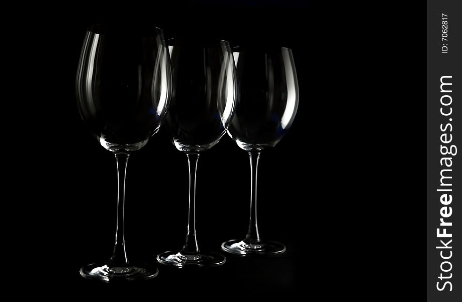 Three wine glasses on a dark background