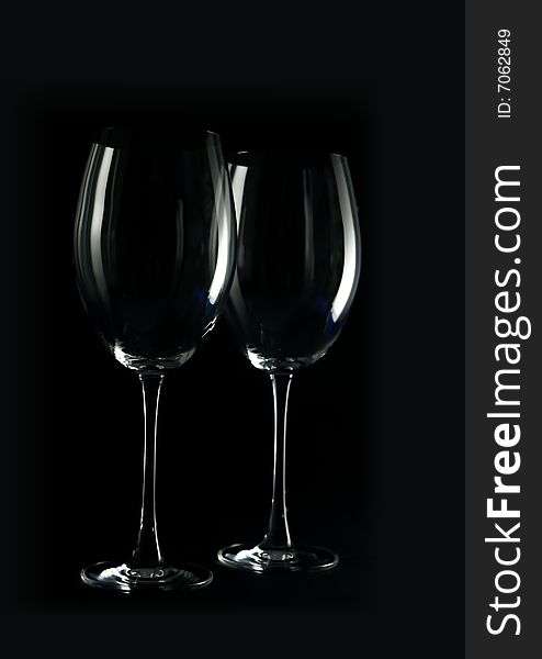 Two wine glasses on a dark background