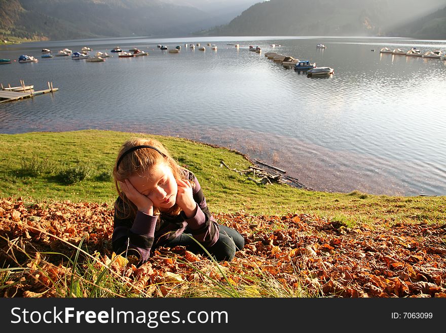 View of the lake WÃ¤gital in Swiss Alps with a girl in the evenings sunbeams. View of the lake WÃ¤gital in Swiss Alps with a girl in the evenings sunbeams