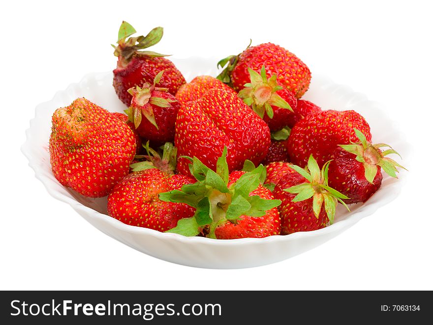 Close-up many ripe strawberries on plate, isolated over white background. Close-up many ripe strawberries on plate, isolated over white background