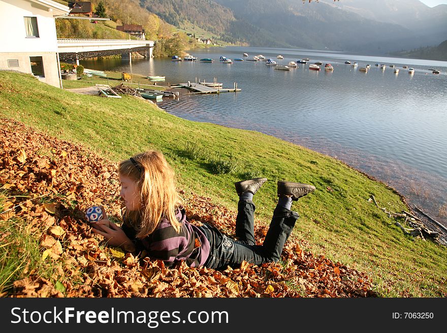 View of the lake WÃ¤gital in Swiss Alps with a girl in the evenings sunbeams. View of the lake WÃ¤gital in Swiss Alps with a girl in the evenings sunbeams