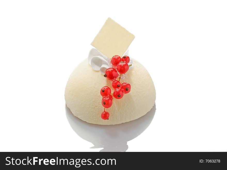 White cake with red currant on acryle glass. White cake with red currant on acryle glass