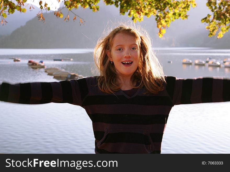 View of the lake Wägital in Swiss Alps with a girl in the evenings sunbeams. View of the lake Wägital in Swiss Alps with a girl in the evenings sunbeams