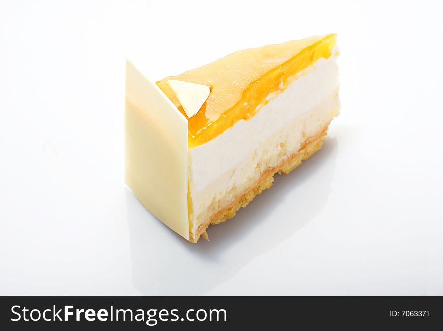 Slice of white cake glazed peach cream on acryle glass. Slice of white cake glazed peach cream on acryle glass.