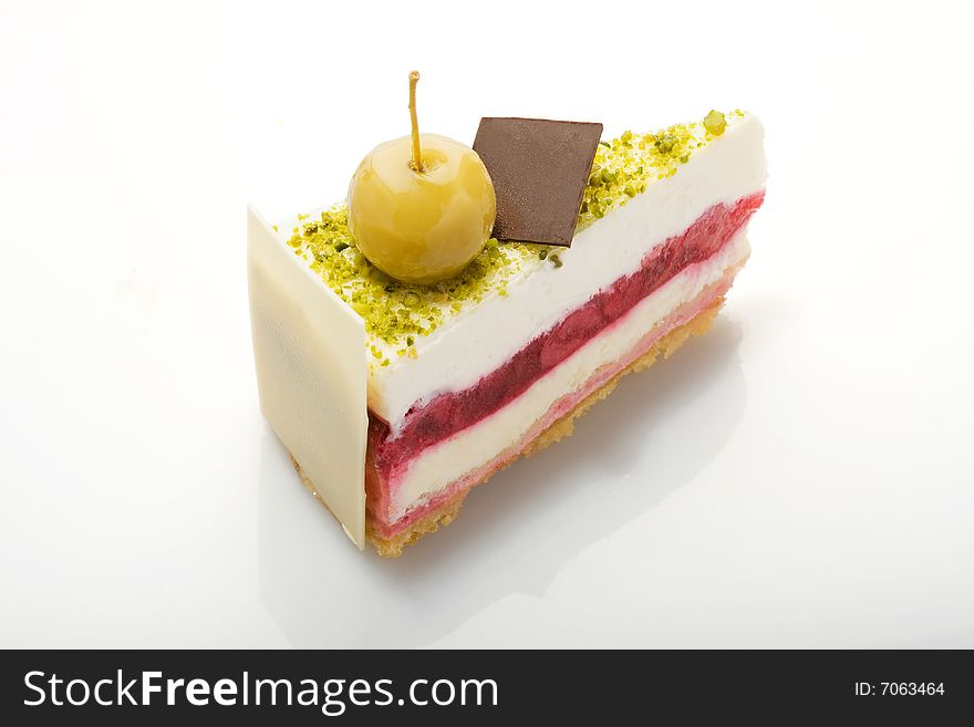 Slice of white cake with pistachioes on acrylic glass. Slice of white cake with pistachioes on acrylic glass.