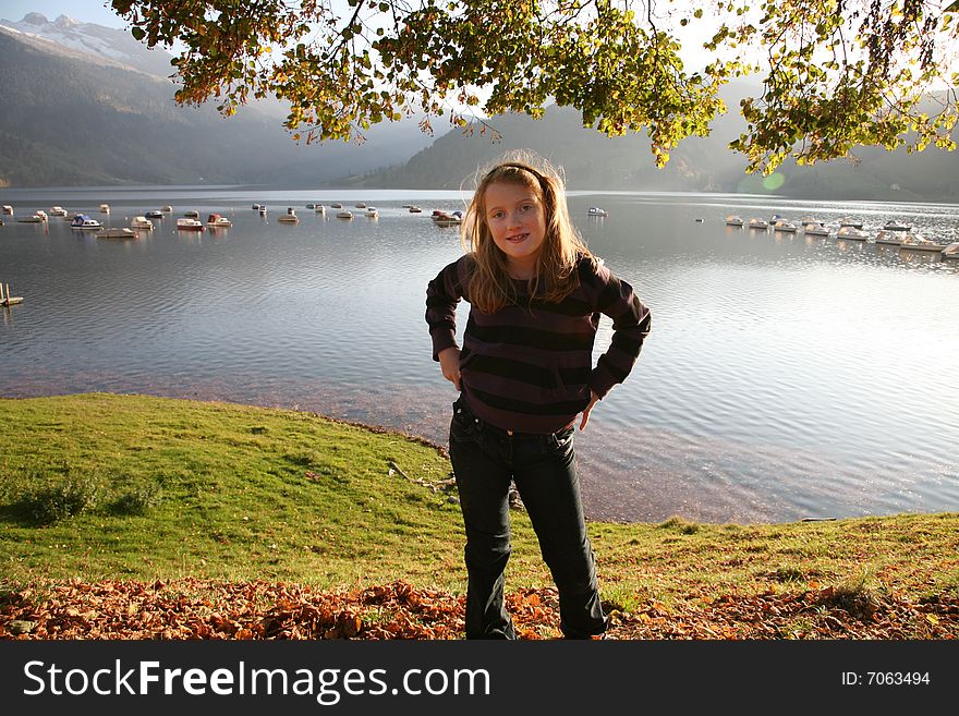 View of the lake WÃ¤gital in Swiss Alps with a girl in the evenings sunbeams. View of the lake WÃ¤gital in Swiss Alps with a girl in the evenings sunbeams