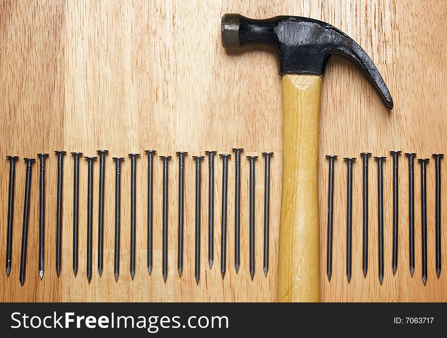 Hammer and Nails Abstract on Wood Background.