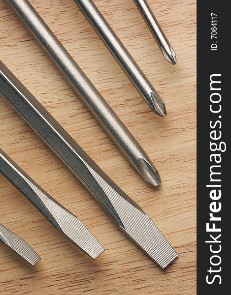 Series of Screwdrivers on a Wood Background.