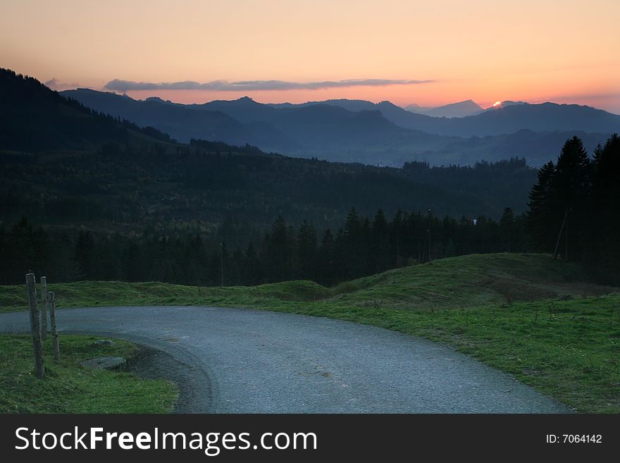 Misty shadows hills with colorful sunrise sky. Misty shadows hills with colorful sunrise sky