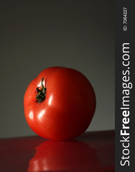 A photograph of a tasty looking tomato fruit.