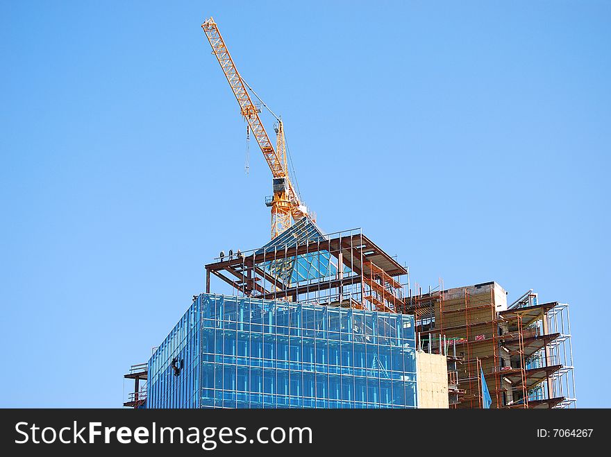 Building construction with crane and people on roof working. Building construction with crane and people on roof working