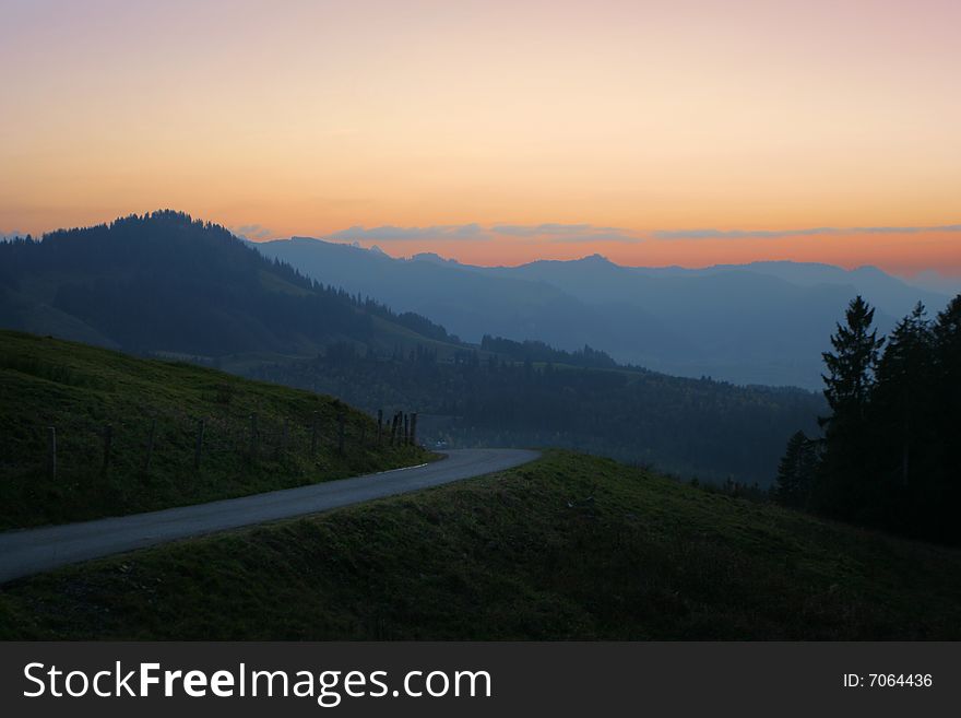 Misty shadows hills with colorful sunrise sky. Misty shadows hills with colorful sunrise sky
