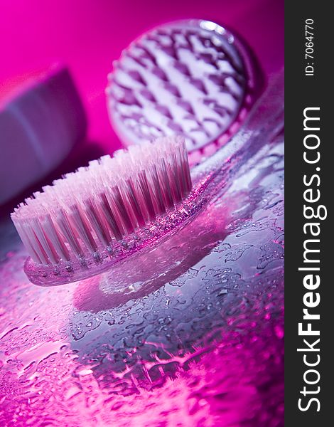 Body brush on a pink glass background