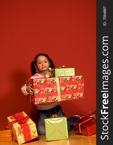 Girl with a big red christmas gifts. Girl with a big red christmas gifts