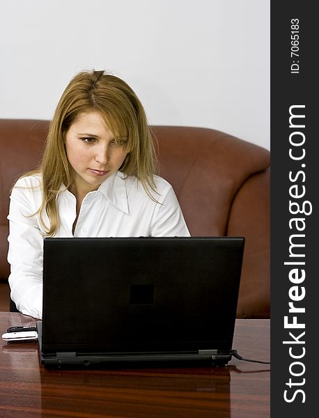 Very beautiful blond business woman working on laptop