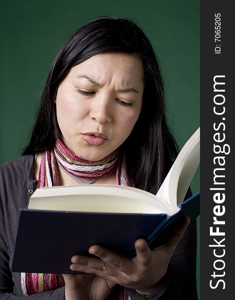 Young Asian woman reading a book
