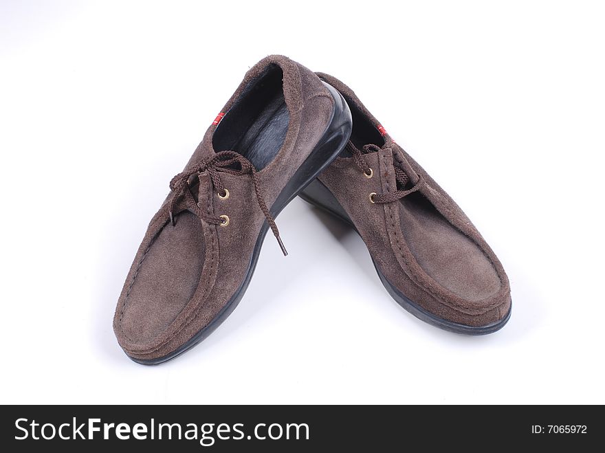 Brown leather shoes on white